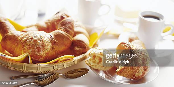 basket of breakfast croissants with black coffee - breakfast pastries stock pictures, royalty-free photos & images
