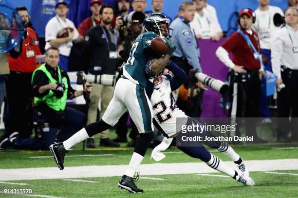 Alshon Jeffery of the Philadelphia Eagles bobbles the pass under pressure from Stephon Gilmore of the New England Patriots in the second quarter of...