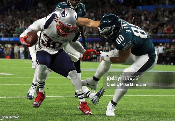 Duron Harmon of the New England Patriots intercepts a pass tackled by Trey Burton of the Philadelphia Eagles during the second quarter in Super Bowl...