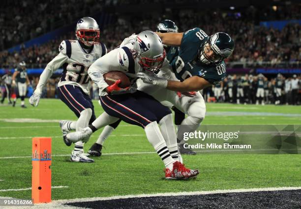 Duron Harmon of the New England Patriots intercepts a pass tackled by Trey Burton of the Philadelphia Eagles during the second quarter in Super Bowl...