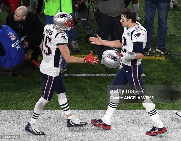 Tom Brady of New England Patriots and teammate Chris Hogan are seen during Super Bowl LII action between the Philadelphia Eagles and the New England...