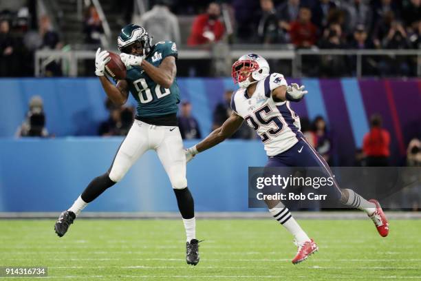 Torrey Smith of the Philadelphia Eagles drops a pass during the second quarter under pressure from Eric Rowe of the New England Patriots in Super...