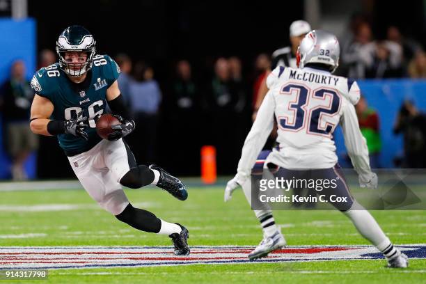Zach Ertz of the Philadelphia Eagles carries the ball against Devin McCourty of the New England Patriots during the second quarter in Super Bowl LII...