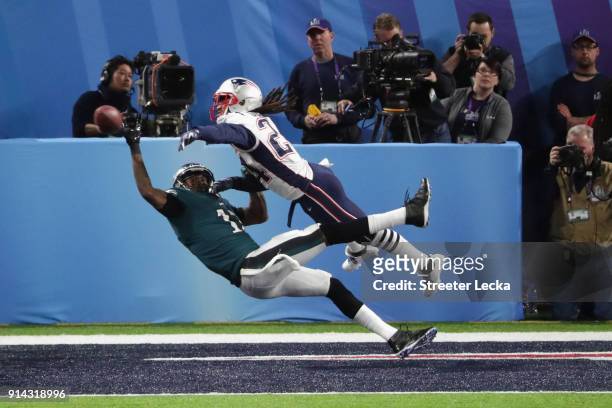 Alshon Jeffery of the Philadelphia Eagles misses the pass attempt under pressure from Stephon Gilmore of the New England Patriots during the second...