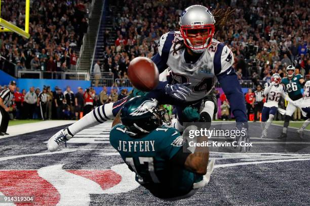 Alshon Jeffery of the Philadelphia Eagles misses the pass attempt under pressure from Stephon Gilmore of the New England Patriots during the second...