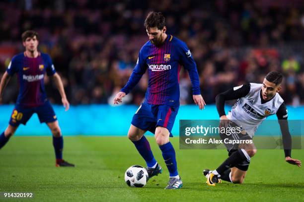 Lionel Messi of FC Barcelona dribbles Andreas Pereira of Valencia CF during the Copa del Rey semi-final first leg match between FC Barcelona and...