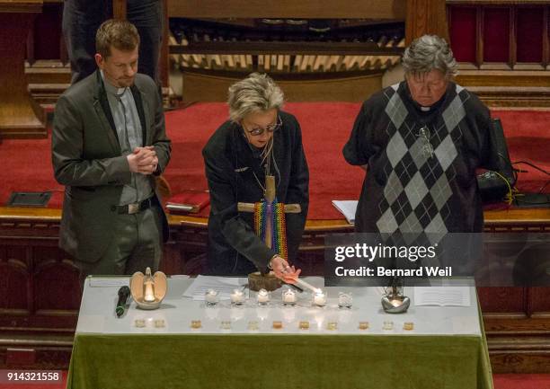 Senior Pastor Rev. Jeff Rock, Rev. Sam Morris and Rev. Deana Dudley light the five candles, one for each of the victims of serial killer Bruce...