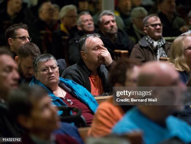 Members of the public packet the congregation at The Metropolitan Community Church, which held a candlelight prayer vigil for the victims of serial...