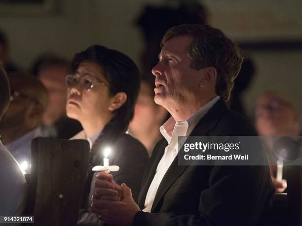 Lights are dimmed as members of the congregation, including Toronto Mayor John Tory, sing the closing song "Channel Your Peace" at The Metropolitan...