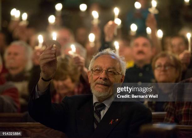 Lights are dimmed as members of the congregation sing the closing song "Channel Your Peace" at The Metropolitan Community Church, which held a...