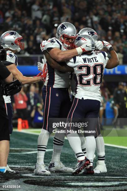 Rob Gronkowski of the New England Patriots celebrates his 5 yard touchdown pass with teammate James White against the Philadelphia Eagles during the...