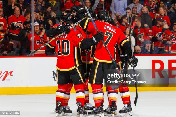 Curtis Lazar, TJ Brodie and teammates of the Calgary Flames celebrate in an NHL game on February 1, 2018 at the Scotiabank Saddledome in Calgary,...