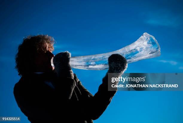 Terje Lsungset, the founder and artistic director of the Ice Music Festival, tests a musical instrument made of ice outside his workshop ahead of the...