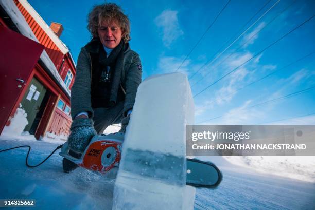 Terje Lsungset, the founder and artistic director of the Ice Music Festival, shapes a musical instrument made of ice outside his workshop ahead of...