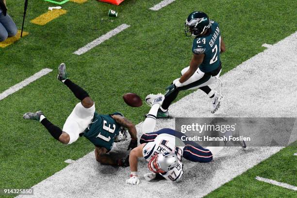 Jalen Mills and Corey Graham of the Philadelphia Eagles break up a pass inteded for Rob Gronkowski of the New England Patriots during the third...