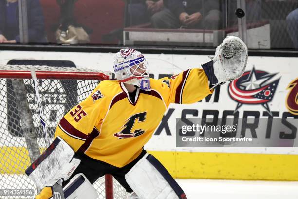 The puck sails over the glove of Cleveland Monsters goalie Matiss Kivlenieks during the second period of the American Hockey League game between the...