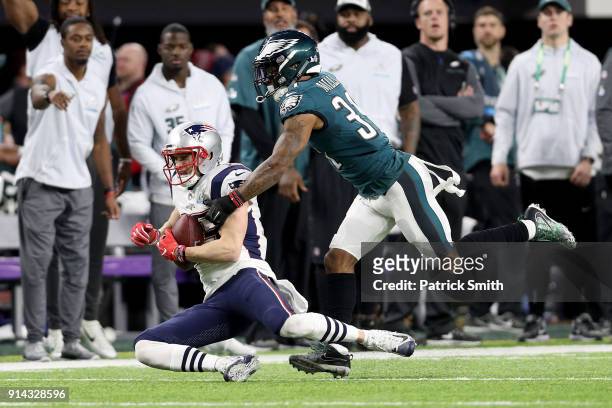 Chris Hogan of the New England Patriots is tackled by Jalen Mills of the Philadelphia Eagles during the third quarter in Super Bowl LII at U.S. Bank...