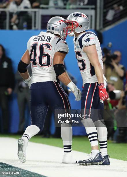 Chris Hogan of the New England Patriots is congratulated by his teammate James Develin after his 26-yard touchdown reception during the third quarter...