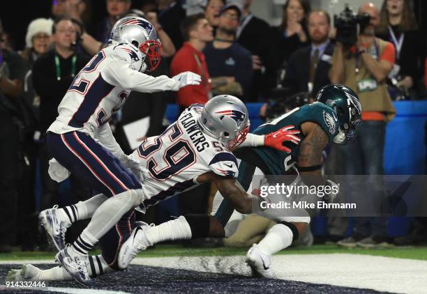 Corey Clement of the Philadelphia Eagles catches a 22 yard touchdown pass against Marquis Flowers and Patrick Chung of the New England Patriots...