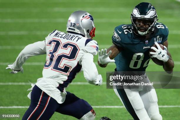 Torrey Smith of the Philadelphia Eagles carries the ball defended by Devin McCourty of the New England Patriots in the third quarter of Super Bowl...