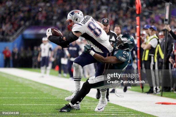 Rob Gronkowski of the New England Patriots is tackled by Corey Graham of the Philadelphia Eagles during the third quarter in Super Bowl LII at U.S....