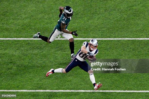 Danny Amendola of the New England Patriots catches a pass defended by Jalen Mills of the Philadelphia Eagles during the second half in Super Bowl LII...
