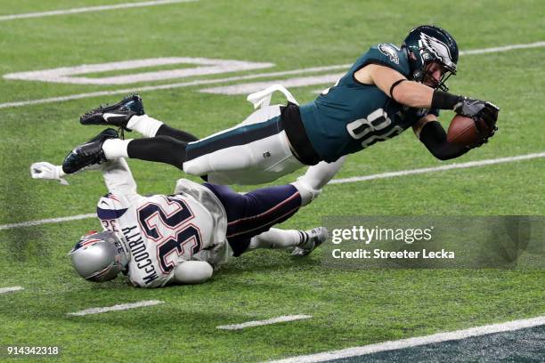 Zach Ertz of the Philadelphia Eagles scores an 11-yard fourth quarter touchdown past Devin McCourty of the New England Patriots in Super Bowl LII at...