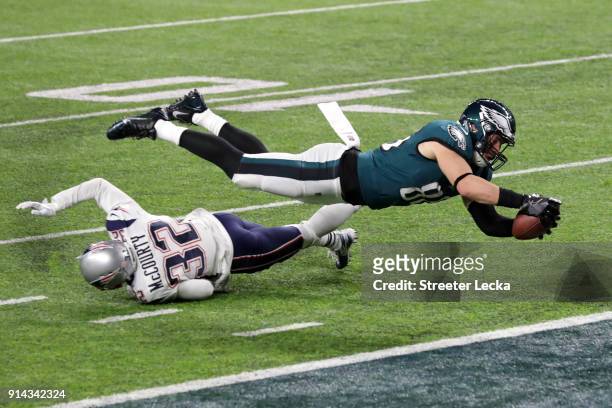 Zach Ertz of the Philadelphia Eagles scores an 11-yard fourth quarter touchdown past Devin McCourty of the New England Patriots in Super Bowl LII at...