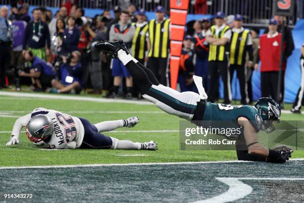 Zach Ertz of the Philadelphia Eagles scores an 11-yard fourth quarter touchdown past Devin McCourty of the New England Patriots in Super Bowl LII at...