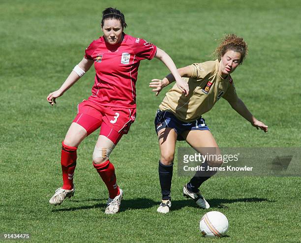 Caitlin Jarvie of the Jets is tackled by Renee Harrison of United during the round one W-League match between Adelaide United and the Newcastle Jets...