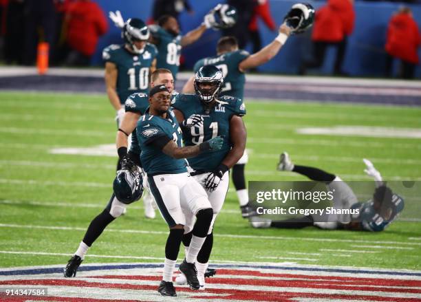 Alshon Jeffery and Fletcher Cox of the Philadelphia Eagles celebrate defeating the New England Patriots 41-33 in Super Bowl LII at U.S. Bank Stadium...