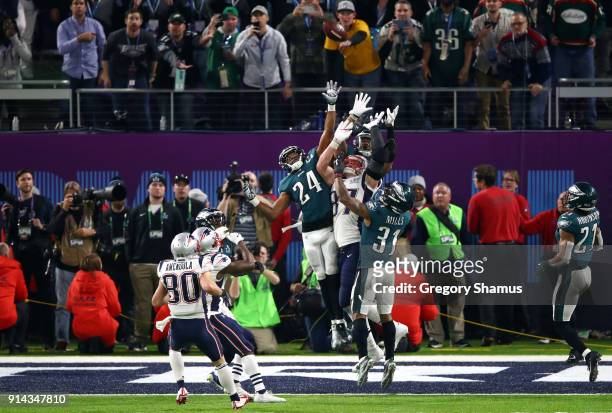 Corey Graham and Jalen Mills of the Philadelphia Eagles go up for a hail mary against Rob Gronkowski of the New England Patriots in the last play of...