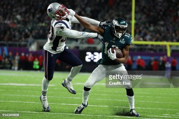 Nelson Agholor of the Philadelphia Eagles stiff arms Duron Harmon of the New England Patriots during the second half in Super Bowl LII at U.S. Bank...