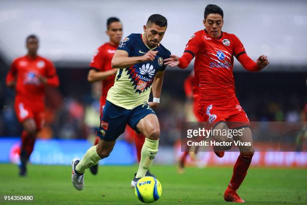 Henry Martin of America struggles for the ball with Eduardo Tercero of Lobos BUAP during the 5th round match between America and Lobos BUAP as part...