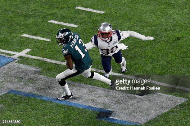 Nelson Agholor of the Philadelphia Eagles breaks a tackle from Devin McCourty of the New England Patriots during the second half in Super Bowl LII at...
