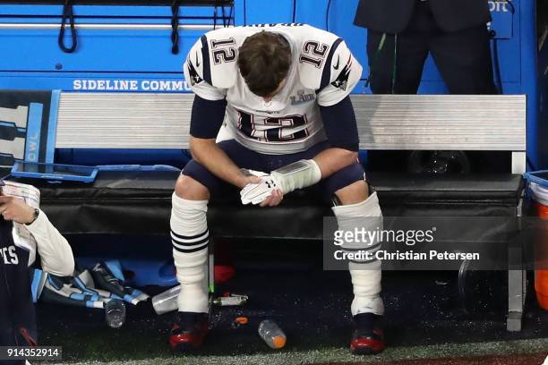 Tom Brady of the New England Patriots sits on the bench after having the ball stripped by Brandon Graham of the Philadelphia Eagles late in the...