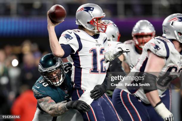 Tom Brady of the New England Patriots attempts to throw a pass under pressure from Derek Barnett of the Philadelphia Eagles during the fourth quarter...