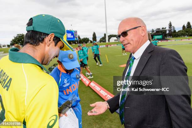 Match referee Jeffrey Crowe presents a selection of coins to captain Jason Sangha of Australia and captain Prithvi Shaw of India prior to the ICC U19...