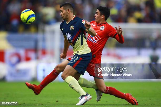 Henry Martin of America struggles for the ball with Eduardo Tercero of Lobos BUAP during the 5th round match between America and Lobos BUAP as part...