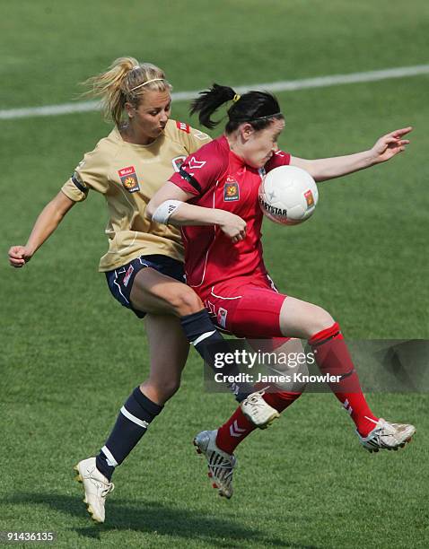 Renee Harrison of United is tackled by Carlie Ikonomou of the Jets during the round one W-League match between Adelaide United and the Newcastle Jets...