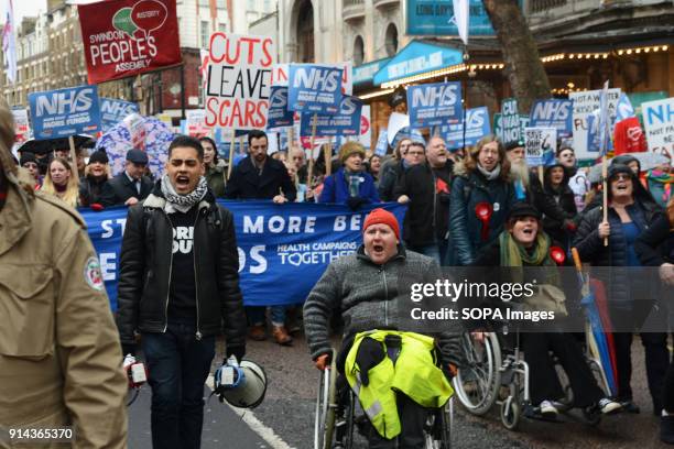 Protesters in a wheelchair seen shouting slogans during the demonstration. Thousand of people marched in London in a protest called "NHS in crisis -...