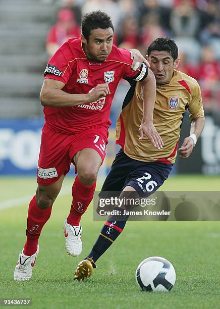 Travis Dodd of United is tracked by Ali Abbas of the Jets during the round nine A-League match between Adelaide united and the Newcastle Jets at...