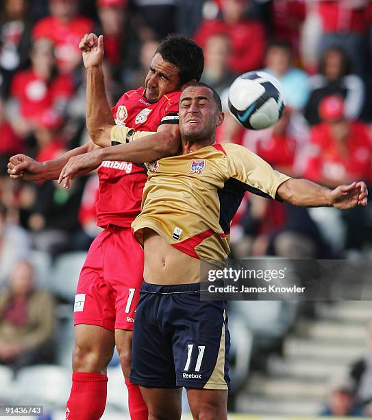 Travis Dodd of United and Tarek Elrich of the Jets head the ball during the round nine A-League match between Adelaide united and the Newcastle Jets...