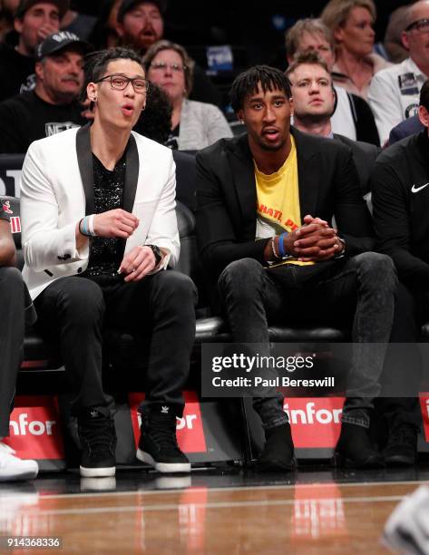 Jeremy Lin of the Brooklyn Nets, who is out for the season after having knee surgery, sits next to Rondae Hollis-Jefferson of the Nets, who did not...