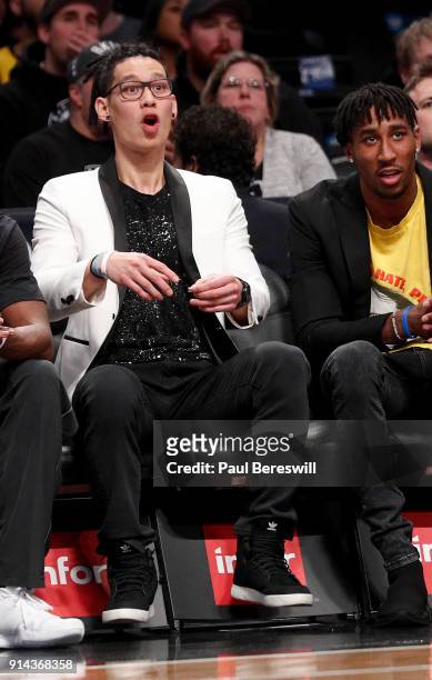 Jeremy Lin of the Brooklyn Nets, who is out for the season after having knee surgery, sits next to Rondae Hollis-Jefferson of the Nets, who did not...