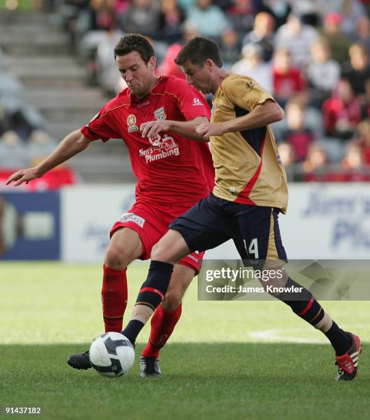 Michael Bridges of the Jets is tackled by Robert Cornthwaite of United during the round nine A-League match between Adelaide united and the Newcastle...