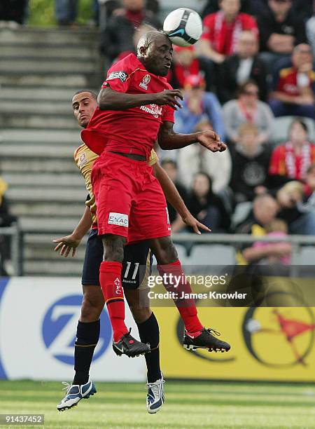 Lloyd Owusu of United heads the ball from Tarek Elrich of the Jets during the round nine A-League match between Adelaide united and the Newcastle...