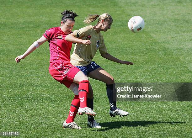 Madeline Searl of the Jets tackled by Renee Harrison of United during the round one W-League match between Adelaide United and the Newcastle Jets at...