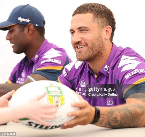 Kenneath Bromwich signs a football for a fan during the Melbourne Storm Family Day on February 3, 2018 in Melbourne, Australia.