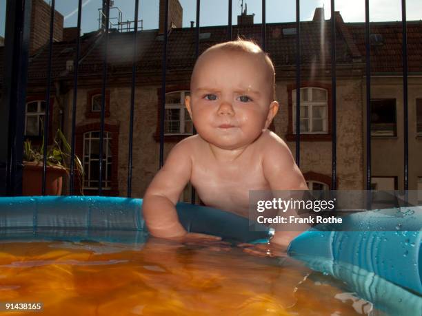 baby looks concerned while testing the water  - testing the water 英語の慣用句 ストックフォトと画像